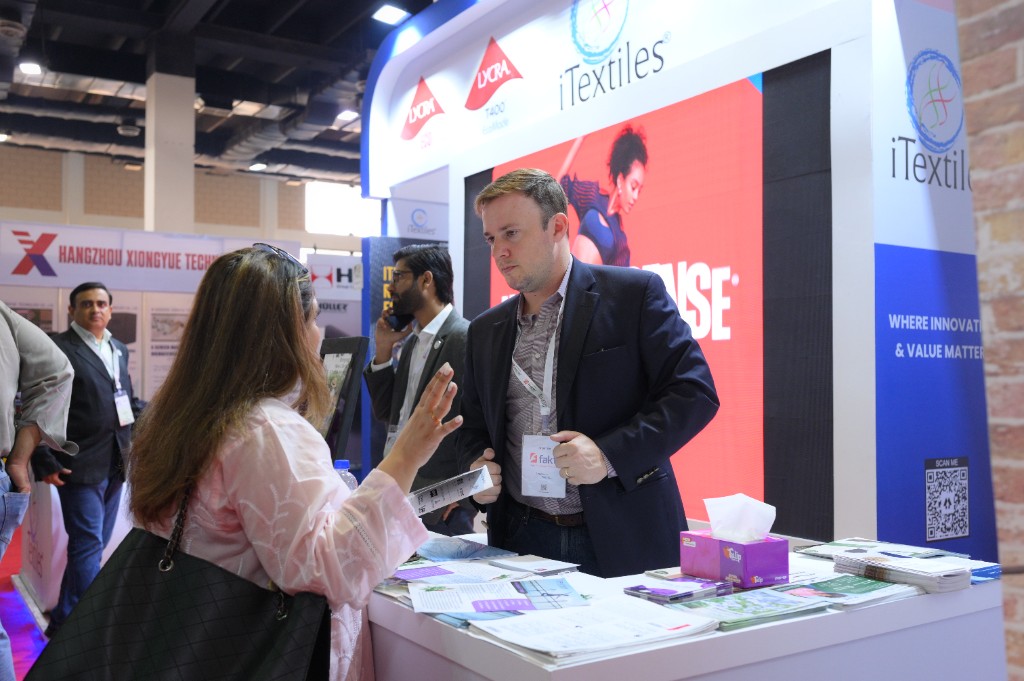 Conversation at the iTextiles booth during an industry exhibition