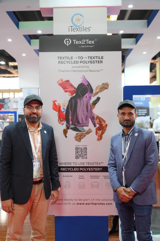 Earth Protex team at a trade show with the Tex2Tex banner